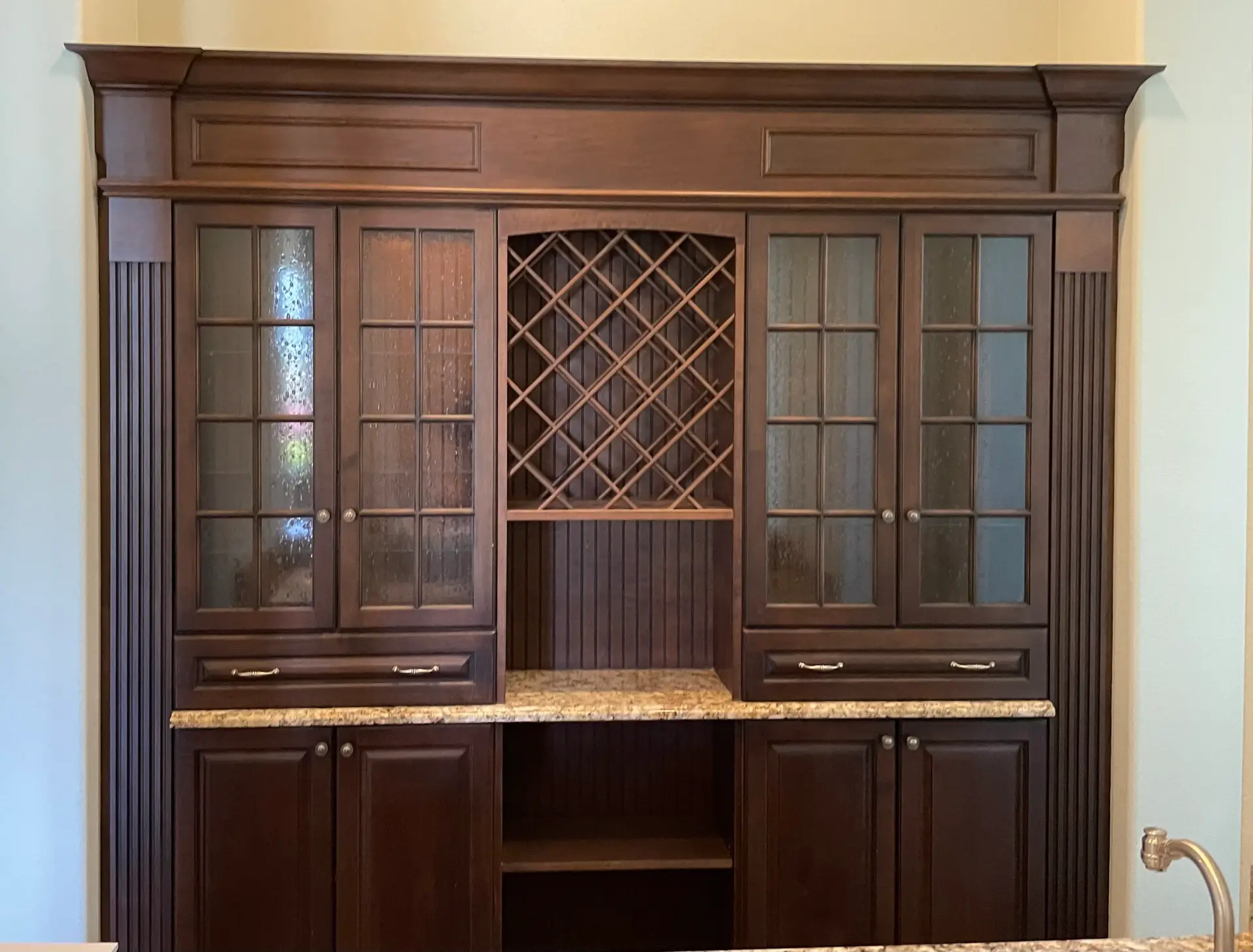 Custom built-in cabinet with leaded-glass doors and an integrated wine lattice