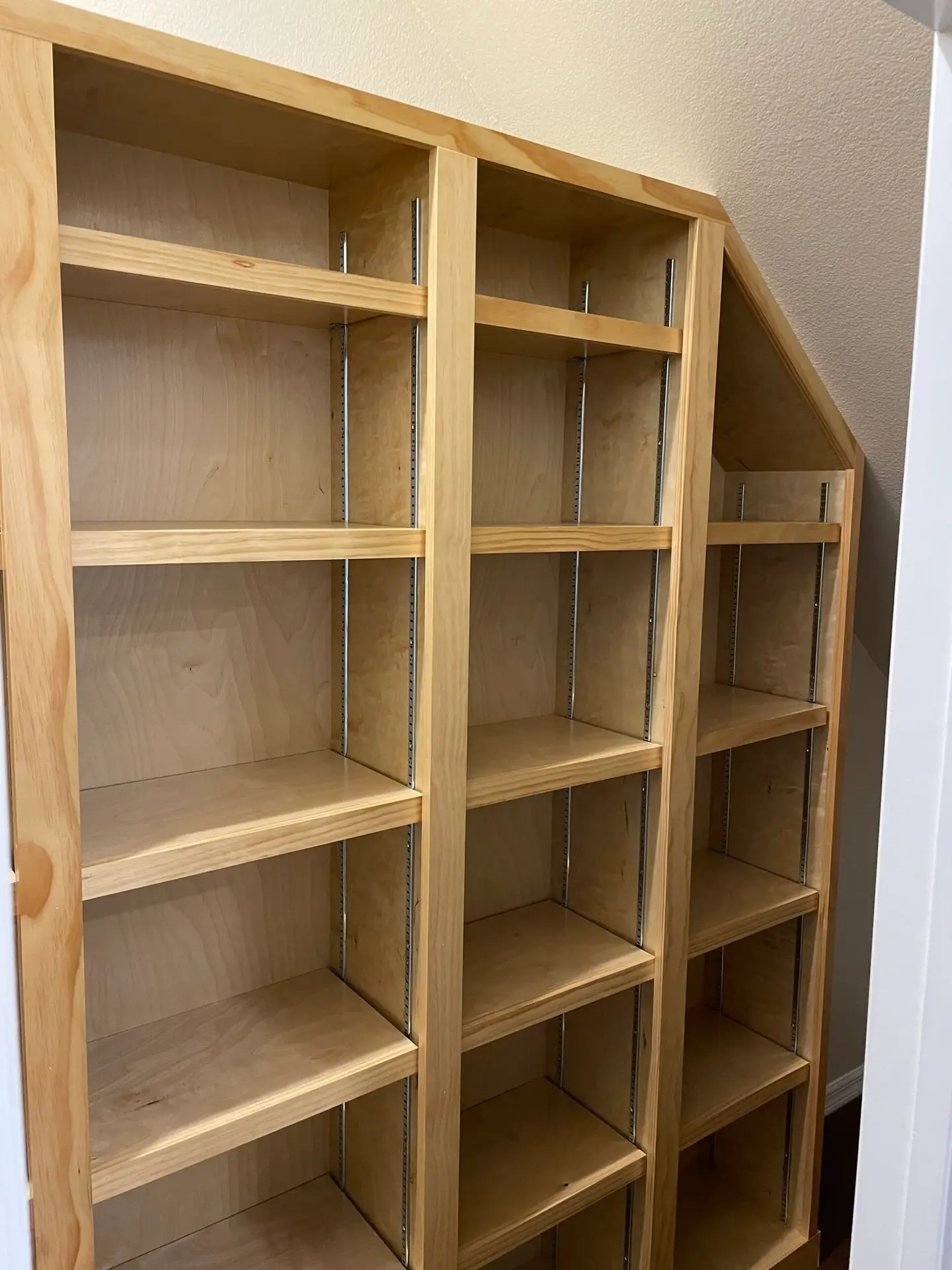 Unfinished built-in shelving unit under construction in the shop