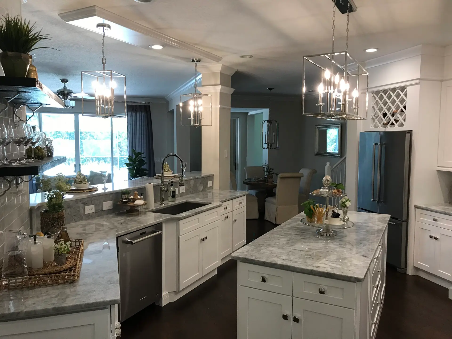 Finished kitchen with a large island, pendant lighting and stone countertops