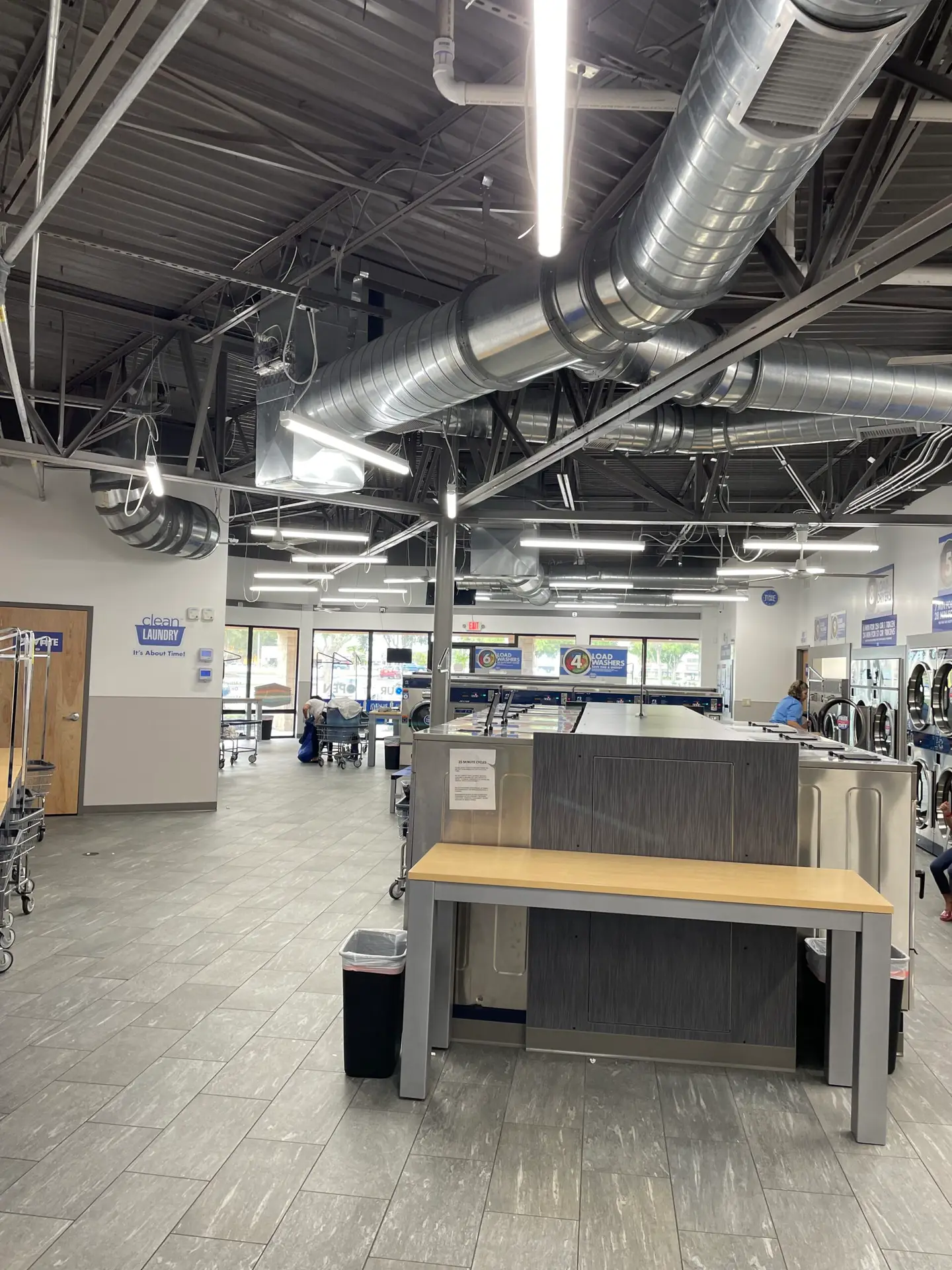 Open commercial floor plate with wide circulation aisles and exposed overhead services