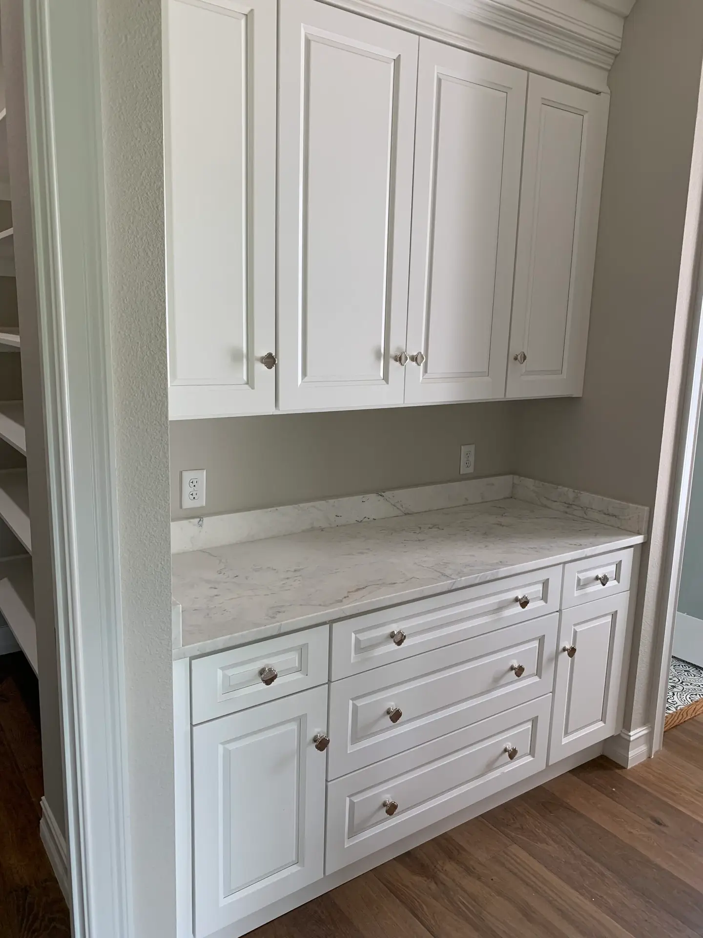 Built-in cabinetry with a drawer bank and upper doors finished in white