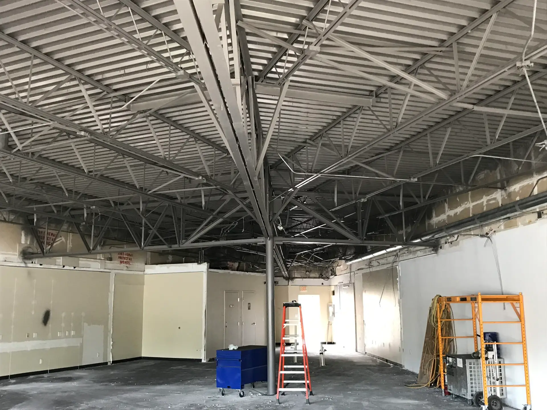 Commercial shell space with exposed structure and partial partitions before fit-out
