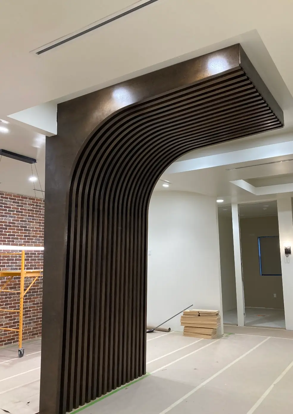 Curved wood slat archway feature framing an interior opening