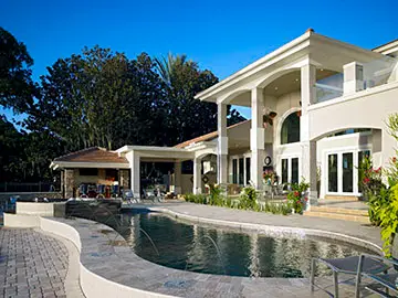 Completed two-story home exterior with a pool deck and covered lanai